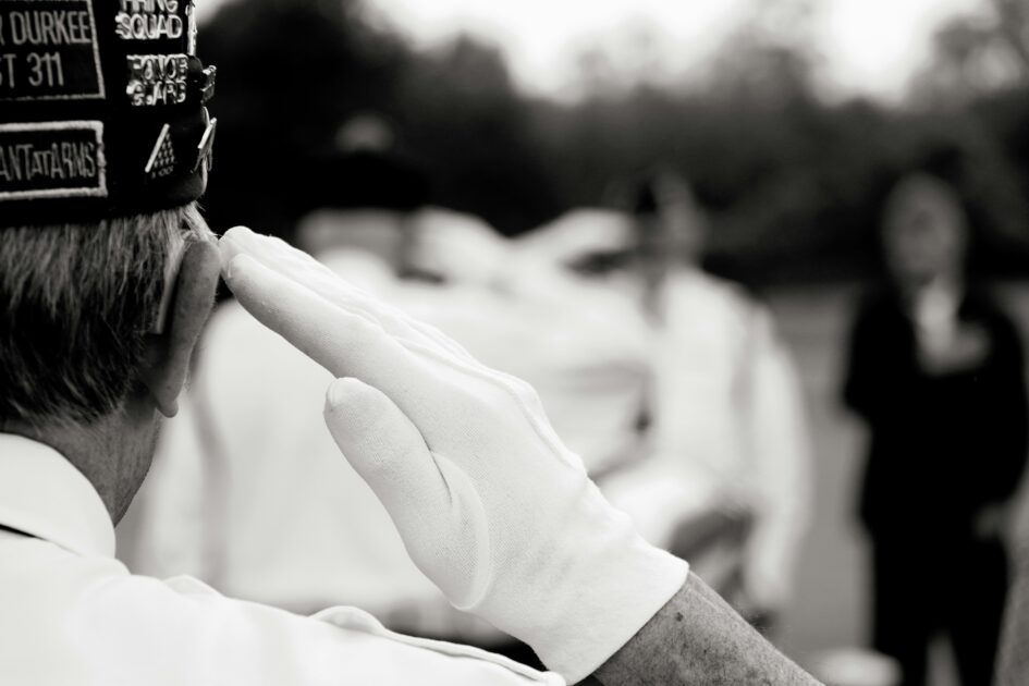 Veteran in formal uniform saluting, symbolizing the official process of filing a VA benefit claim.