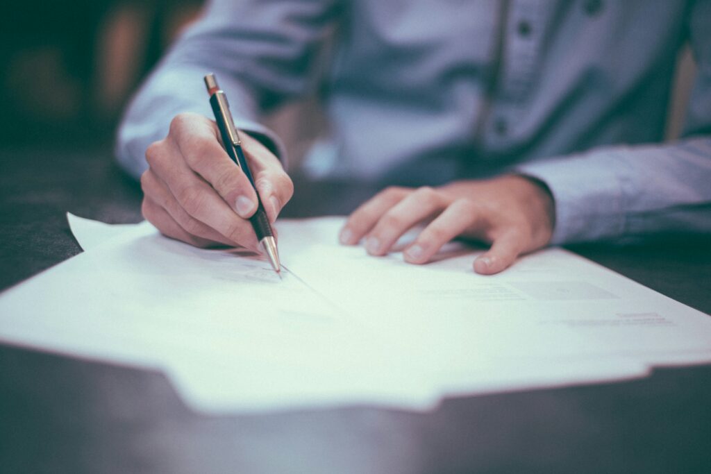 Older adult reviewing financial notes at home, representing asset protection through a Spendthrift Trust